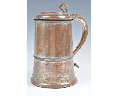 An 18th Century copper tankard and lid having an oak base with remains of original silver plate/ Shaped handle with circular 