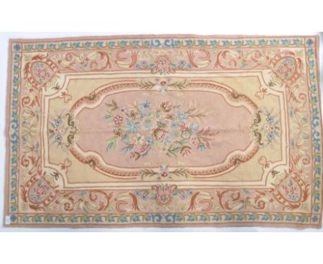 An 18th Century style aubusson carpet rug being hand made having embroidery crewel work throughout. The central floral medall