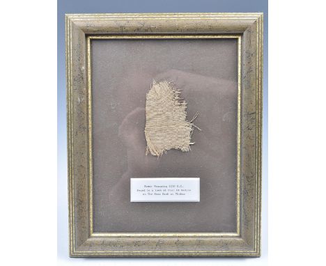 Ancient Egypt - A piece of woven mummy wrapping dating from the new Kingdom period circa 1250 BC, set within a gilt frame wit