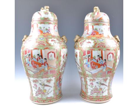 A pair of 19th Century Chinese large Famille Rose temple jars / vases and covers having hand painted decoration depicting cou