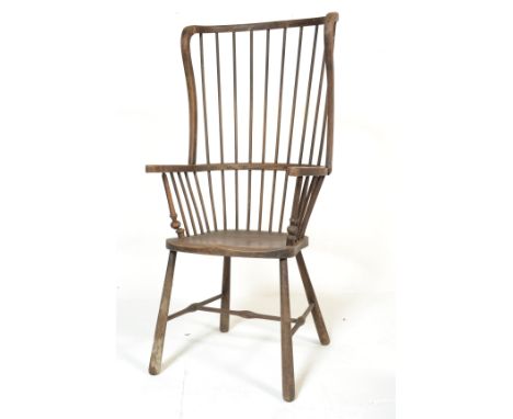 A 19th century Scottish comb back Windsor chair. Raised on turned legs with elm wood seat, bobbin turned elbow rest uprights 