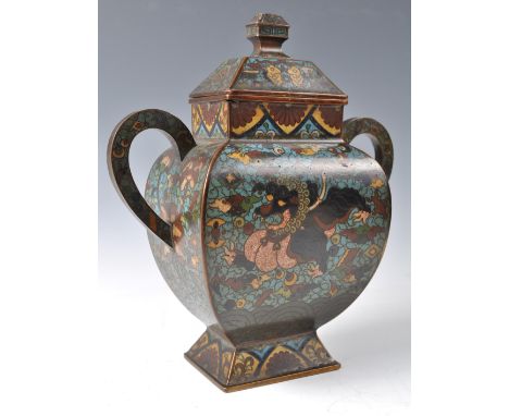 An 18th / 19th Century Chinese cloisonne vase / jar having twin scrolled handles with sarcophagus finial lid. Blue enamel fin
