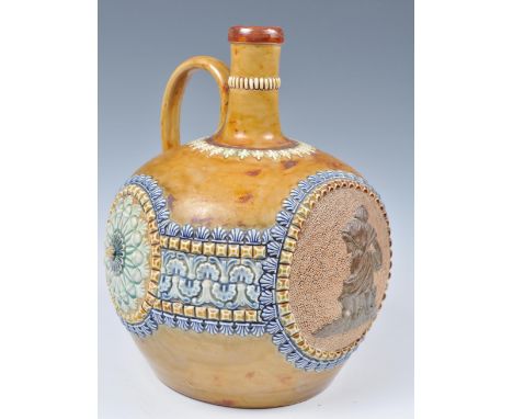 A 19th century Doulton Lambeth stoneware glazed ewer jug. Mustard glaze with embellished banding having two large cartouche p