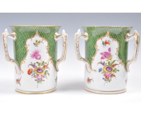 A pair of early 20th Century Dresden porcelain vases of cylindrical form having three handles to each. Hand painted with flor