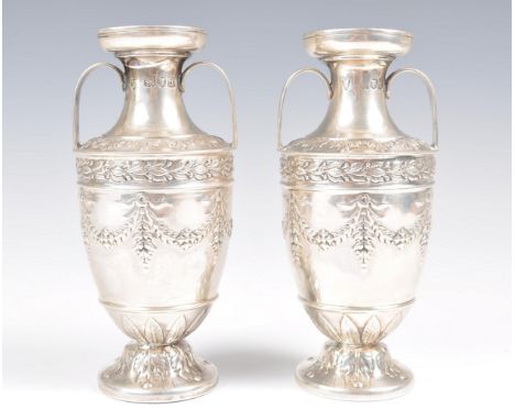 A pair of late 19th Century Victorian hallmarked silver vases of urn shape by R H Halford &amp; Sons raised on circular bases