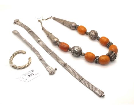 A Bedouin Amber Colour Bead Necklace, with textured spacers and chain; A Six Row Smooth Link Necklace, with applied detail an