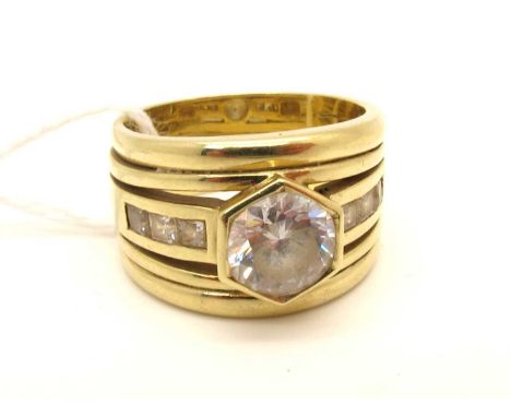 A Modern 14ct Gold Single Stone Dress Ring, octagonal rubover set, between channel set shoulders and reeded band (finger size