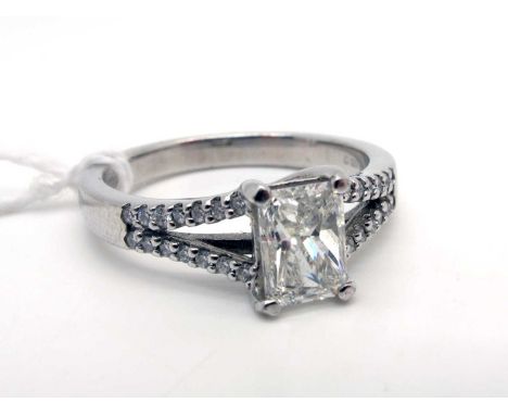 A Modern 18ct White Gold Single Stone Diamond Ring, the central radiant cut diamond four claw set, between diamond set bifurc