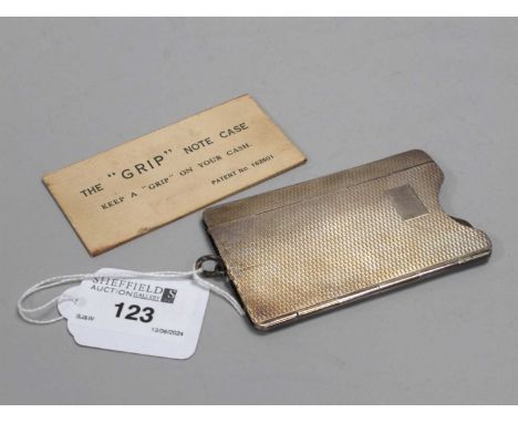 A Hallmarked Silver The "Grip" Note Case, (marks unclear) allover engine turned decoration (sprung hinge), 8.7cm long, with s