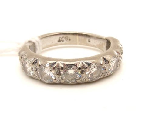 A Diamond Set Half Eternity Band, set throughout with eight uniform brilliant cut stones, stamped "18ct" (finger size M).The 