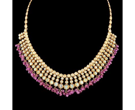 A cat's eye and ruby gold fringe necklace, thirty-nine articulated panels set with a total of 117 cat's eye stones set in gro
