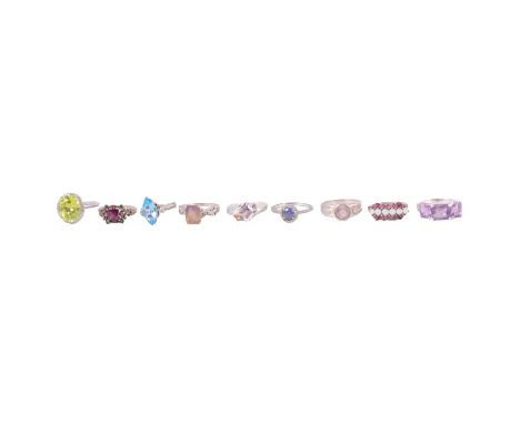 Twenty gemset white metal rings, a peridot and white stone (not diamond) ring, the circular mixed cut peridot with six white 