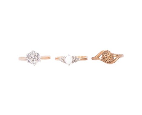 Thee rings, a diamond cluster, opal and gold, a seven stone diamond cluster ring, 9 carat yellow gold ring size L; a 9 carat 