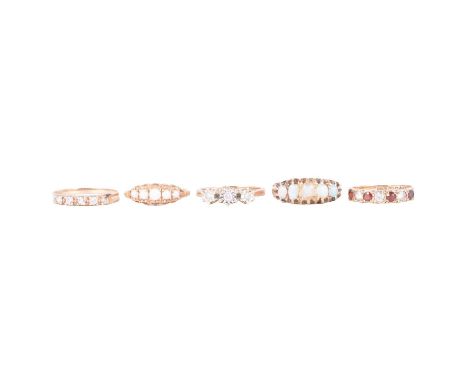 Five gemset gold rings, a diamond three stone ring, the three brilliant cut stones collet set in 9 carat white gold metal wit