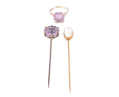 Two tie pins and an amethyst dress ring, an oval 11mm Mabe pearl tie pin, claw set in a yellow metal mount testing as gold; a