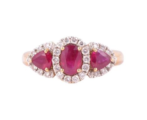 A ruby and diamond cluster ring, the central oval brilliant cut ruby surrounded by fourteen brilliant cut diamonds with a tri