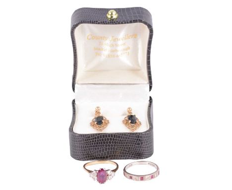Two ruby and diamond rings, and a pair of sapphire earrings, a ruby and diamond ring, the oval mixed cut ruby with three bril