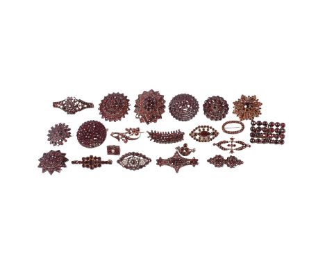 Twenty-one garnet brooches, a garnet snowflake brooch, the brilliant cut central stone surrounded by nine 8 cut stones with e