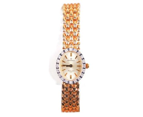 Sovereign - a lady's 9 carat yellow gold bracelet wristwatch with diamond bezel, 15x13mm oval champagne raised baton dial in 