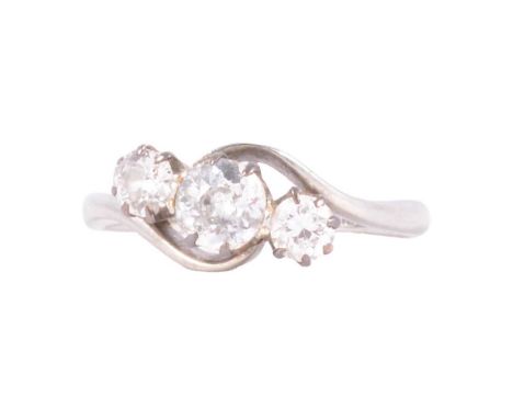 A diamond three stone ring, the old brilliant cut stones graduating in size claw set in an all white metal mount ring size K,