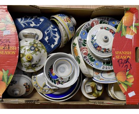 A collection of Continental earthen ware including serving bowls, plates, tureens and covers, some stamped Quimper style Fren