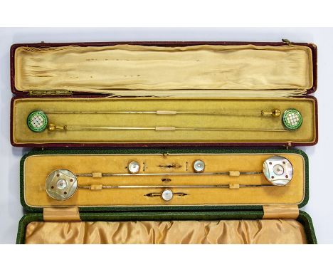 A pair of Edwardian enamelled hat pins, green and white enamel, fitted case; a cased set of paste and mother-of-pearl hatpins
