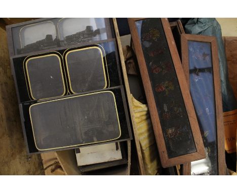 A collection of stereoscope slides and magic lantern slides within wooden box