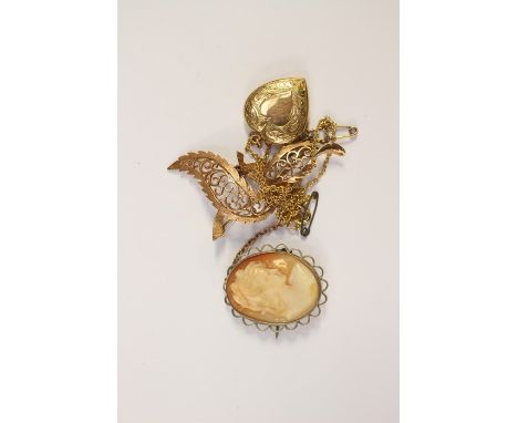 A 9ct gold heart shaped locket on gilt chain, a 9ct gold openwork leaf shaped scroll brooch total gross weight approx. 8.5g a