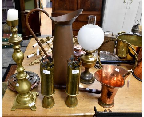 A selection of mostly French brass and copperwares including an original oil lamp and a pair of trench art