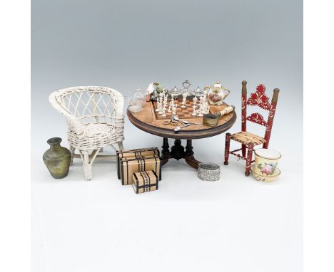 A delightful 49-piece collection of miniature dollhouse furniture and accessories, including an intricately designed chess se