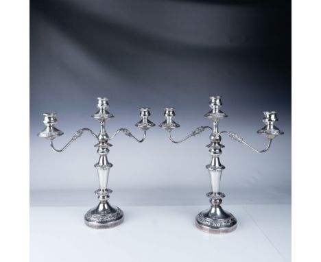 This elegant pair of silver-plated five-light candelabras features intricate scrollwork and floral detailing on the arms and 