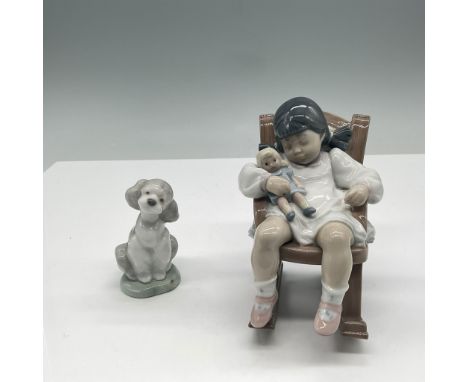 A delightful pair of Lladro porcelain figurines featuring Naptime (4"H) peacefully resting on a rocking chair while holding a