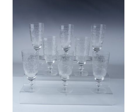 This elegant set of eight crystal goblets stands at 7 inches tall and features detailed, intricate floral etching on the body