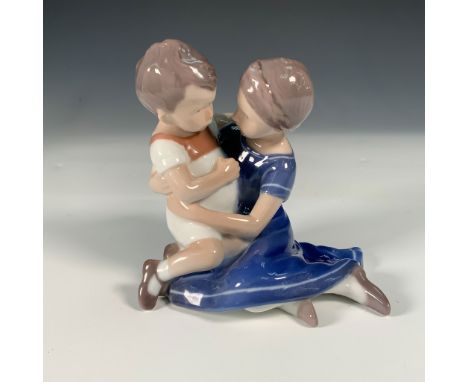 This charming Bing &amp; GrÃ¸ndahl porcelain figurine features a boy and girl seated together, captured in an affectionate mo