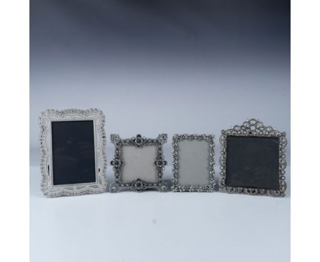 This lot includes a set of four decorative picture frames, each featuring intricate metalwork adorned with crystal detailing.