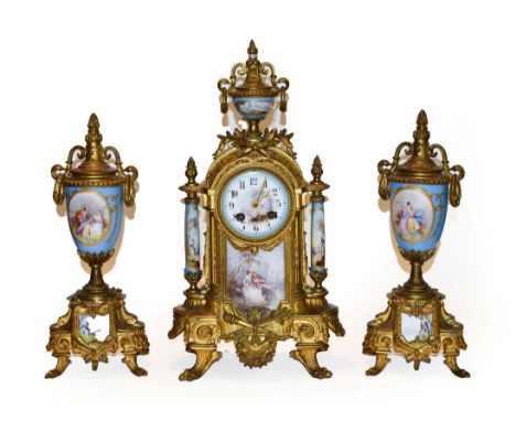 A gilt metal porcelain mounted striking mantel clock with garniture, circa 1890