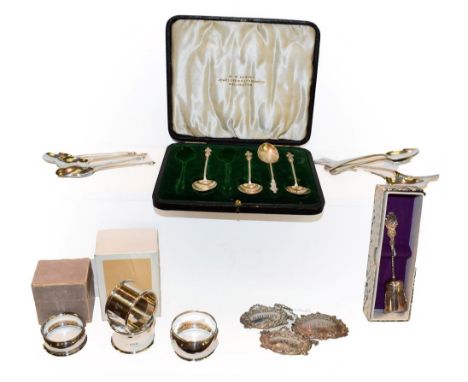 A collection of assorted silver, including four various napkin-rings, three modern decanter labels and assorted flatware, 7oz