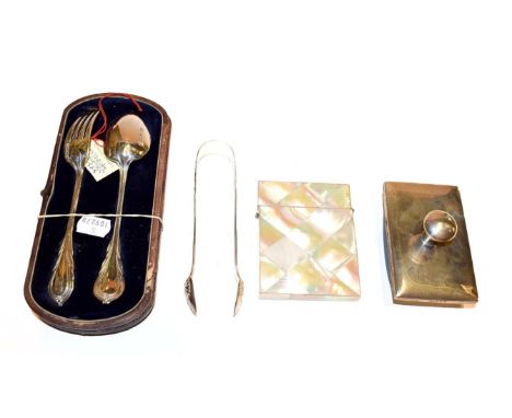 A Victorian cased silver christening set, silver mounted desk blotter, pair of kings pattern sugar tongs and a mother of pear