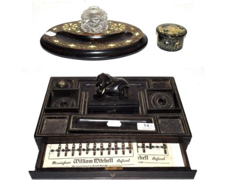 A 19th century Anglo Indian ebony desk Standish surmounted by an elephant, a Victorian Coromandel ink stand and a thread disp