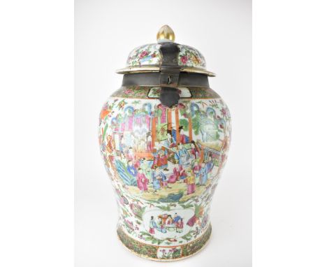 A large Qing Dynasty Canton porcelain vase and cover, 19th century of baluster shape, the domed lid fitted with a metal hinge