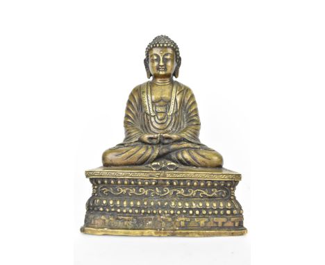 A Sino-Tibetan lacquered bronze or brass statue of Buddha in Dhyana Mudra on a casted base with Vijra positioned by Buddha's 