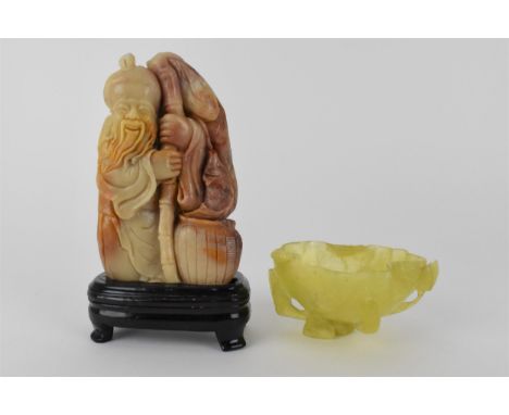 A Chinese yellow/pale green jade bowl, fashioned as a leaf and other plants, 4.5cm high, 8.5cm wide and a soapstone figure of