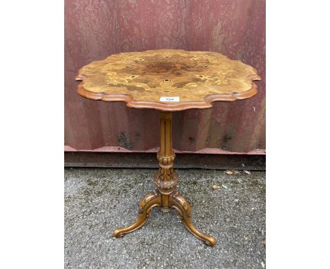 A Victorian walnut occasional table having a burr walnut and marquetry inlay piecrust top, fluted column and tripod base with