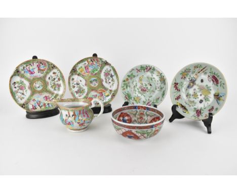 Chinese Qing dynasty porcelain comprising of a 19th century Canton jug and a pair of plates, decorated with panels of birds i