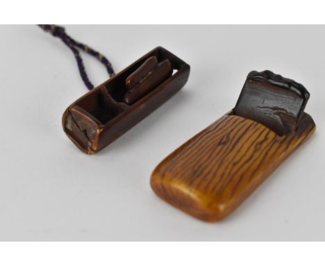 Two Japanese 19th century stained ivory netsuke, one a woodworking plane with text to the underside (friends), 50cm l and the