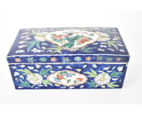 A Chinese late Qing Dynasty porcelain brush box, 19th century, with a domed cover and straight sides, enclosing two compartme