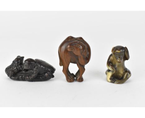 Three 20th century netsuke, one of a camel and another of two frogs on a lily pad, signed to the base and a horn netsuke of a
