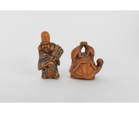 A Quin dynasty and a later wooden netsuke of a deity wearing a robe and holding a fan with painted detail, 5.3cm h and the ot