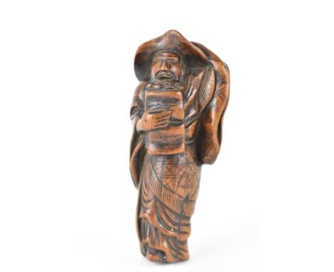 A Japanese Edo period (18th/19th century) wooden netsuke of a scholar holding his hat on, 9.5cm h 