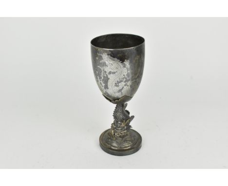 A Chinese export silver goblet modelled with a dolphin stem on a circular base, the dolphin with detailed scales above a dome